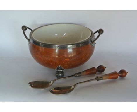 A good quality coopered oak salad bowl with ceramic liner raised on three extensive ball supports with further ball and threa