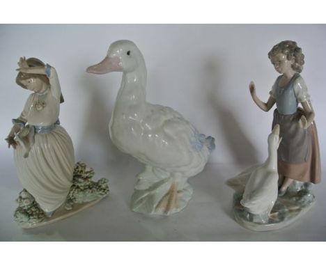 A Nao figure group of a young girl accompanied by a pair of geese, a further Nao figure of a girl feeding a dove and a Spanis