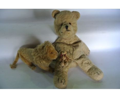 A vintage Steiff model of a standing male lion with inset pale glass eyes and remnants of label and stud to ear with all over