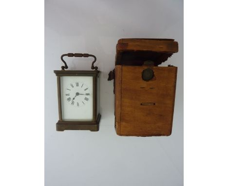 A brass carriage clock with eight day timepiece, enamel dial and original travelling case