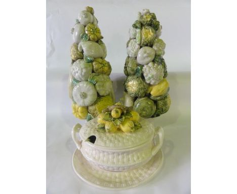 A pair of continental ceramic towers of vegetables including garlic, cauliflowers, squashes, etc, predominantly glazed in gre