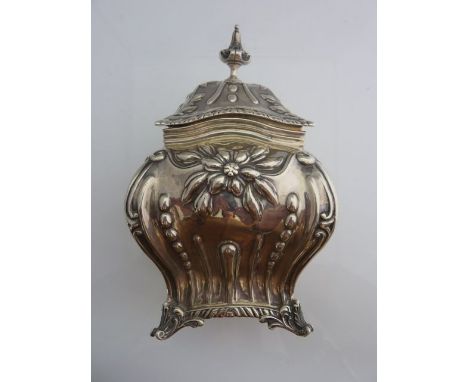 A late Victorian silver tea caddy, William Hutton & Sons, London, 1897, the lobed baluster rectangular body chased with flowe