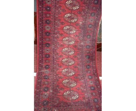 A Keshan red ground runner with multi-medallion centre within alternating borders, 390 x 90 cm approx