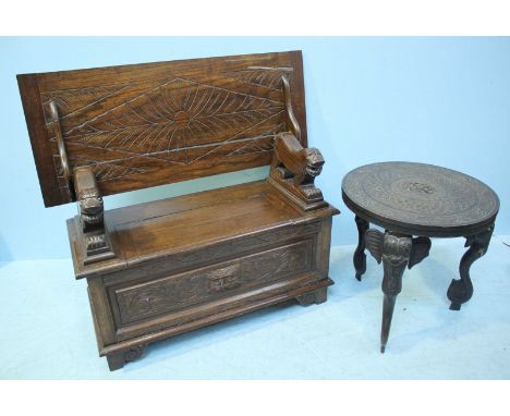 An Indian stained hardwood table, the carved circular top, raised on carved supports modelled as elephants with bone tusks, 5