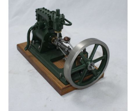 A well-engineered Halls Rotary Steam Engine, possibly turbine, with six-spoke flywheel, finished in green, on wooden plinth, 