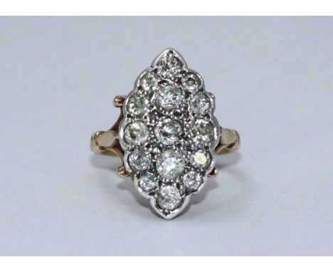 An antique diamond ring, the white-gold elliptical top set with 15 graduated Victorian Cushion-cut diamonds, estimated approx