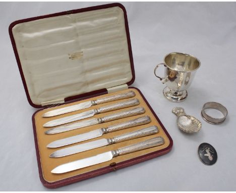 A quantity of silver items including a silver cup, a napkin ring, a caddy spoon, a brooch and a cased set of six silver desse