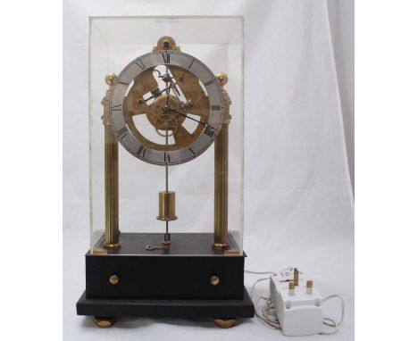 A well-engineered and constructed brass mantel clock, with electric-powered movement, front-to-back swinging pendulum engagin