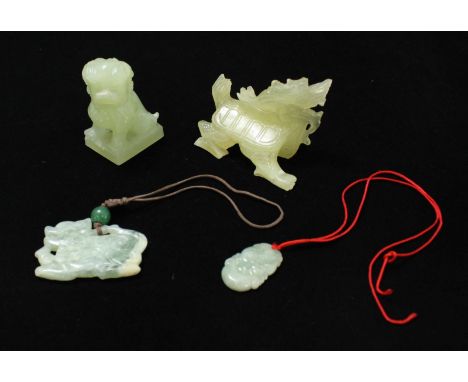 A jade pendant modelled as a monkey and a jade coloured dragon pendant, together with a jade coloured figure of a fo dog and 