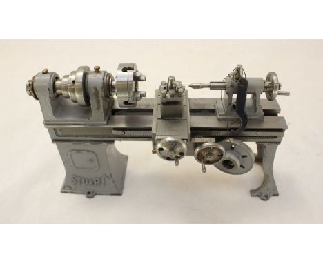 A Stuart scale model engineers lathe, finished in grey, 21cm wide, engineered and built by the late John Dilly of Eastleigh, 