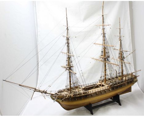 A hand-built wooden scale model of a fully-rigged three-mast 54-gun ship, with planked and pinned hull, on stand, 95x69cm