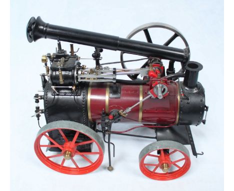 A well-engineered scale model live steam traction engine, with folding chimney, finished in maroon and black, 62cm to chimney