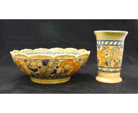 A Crown Ducal bowl and matching vase, designed by Charlotte Rhead, decorated with a tube lined floral design to a mottled yel