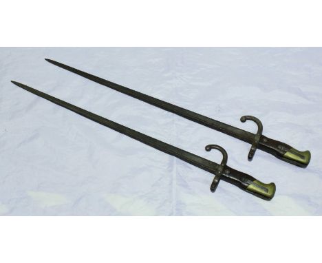 Two late 19th century French rifle bayonets, each with 20.5 inch blade with flat top edge, muzzle ring and scrolled Quillon, 
