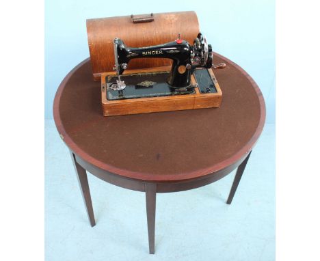 An early 20th century demi-lune folding card table, the top lifting to reveal a brown playing baize, 96cm wide, together with