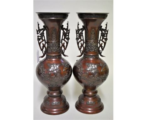 A pair of Japanese bronze twin handled vases,&nbsp;Meiji, relief decorated with birds in flowering branches, 36.5cm high.&nbs