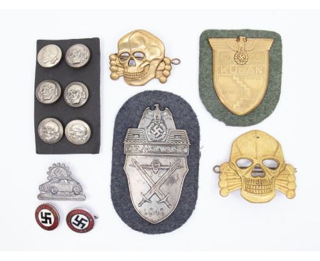 A selection of German badges and insignia.To include: a gilt washed ‘Kuban’ shield with paper backing, a ‘Demjansk’ shield wi