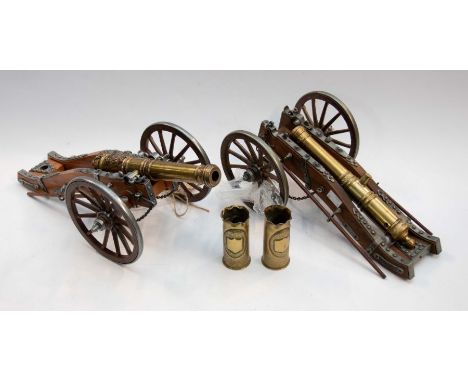 A matched pair of Louis XIV era model cannons, gilt brass barrels sat upon a pewter mounted wooden carriage, made in Spain by