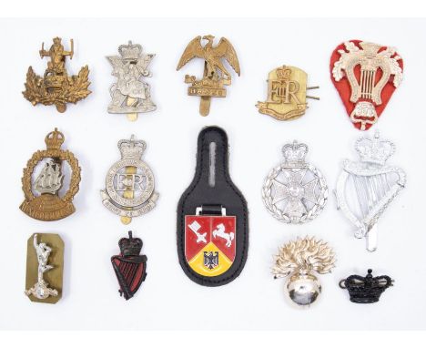 A selection of post WW2 regimental cap / sleeve badges.Various regiments and corps, some with makers marks to the reverse.Plu