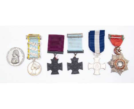 A selection of reproduction medals.To include: a Victoria Cross army issue, a Victoria Cross naval issue (named to the revers