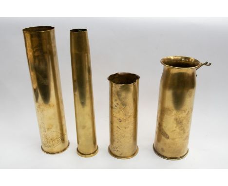 Four brass artillery shells of various dates, including a German 75mm shell, dated 1917, faint engraving featuring the Cheshi
