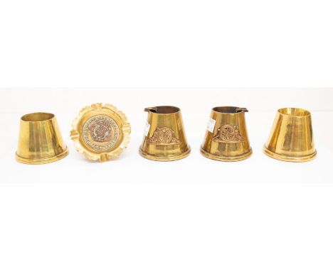 A pair of brass trench art ashtrays, believed to be fashioned from fuse caps, with applied Royal Artillery collar badges, plu