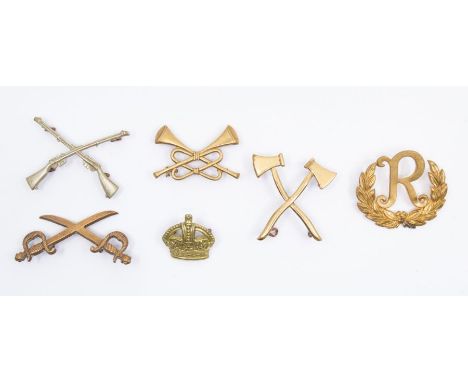 A collection of WWI inter war period brass trade/rank sleeve badges, including a brass Pioneer badge with lugs, a brass Sword