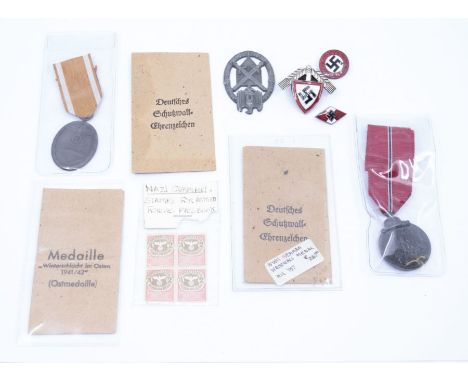 A selection of 1933-1945 German medals and insignia.To include: an Eastern Front Medal, with original paper issue envelope, a