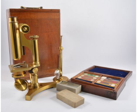 R & J Beck, London. lacquered brass microscope in a mahogany case, together with a Victorian mahogany slide case, (2)