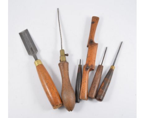 Collection of hand tools, including planes, chisels, etc.