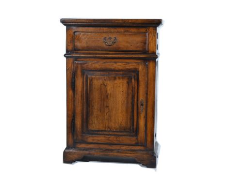 Reproduction oak pedestal cupboard, single drawer over a panelled door, bracket feet, 61cm.