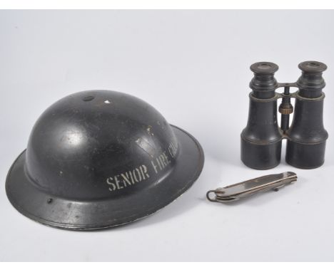 Two medical wall hangings, case with senior fireguard helmet, tin helmet, pair of field glasses, and penknife.