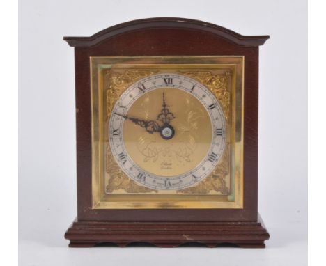 Elliott mantel clock, retailed by Tarratt's, cast gilt spandrels on square brass dial, stained wood case, 16cm.
