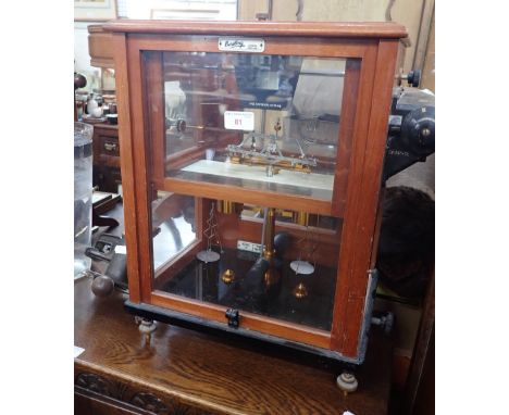 A SET OF VINTAGE 'OERTLING' SCIENTIFIC SCALES, in a glazed mahogany case, 48cm high