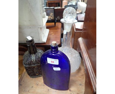 A DECANTER WITH EMBOSSED DECORATION, a blue glass flask and a wire covered bottle (3)