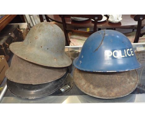 A STEEL POLICE HELMET, and four other steel helmets