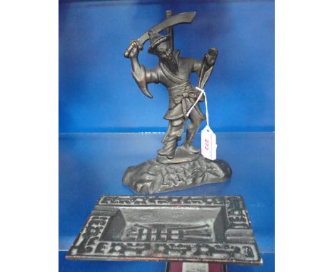 A CHINESE CAST IRON TABLE LAMP decorated with a warrior, 22cm high and a similar ashtray