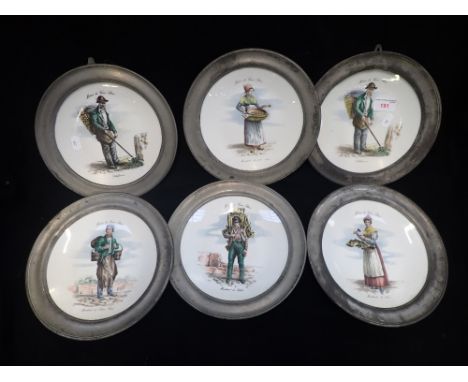 A SET OF SIX FRENCH CERAMIC PLATES depicting characters from Old Paris, each with pewter frames, 23cm dia