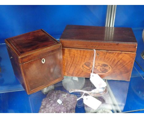 A GEORGE III MAHOGANY TEA CADDY with central shell inlay to the front, 20.5cm wide, a similar caddy of cube form and a silver
