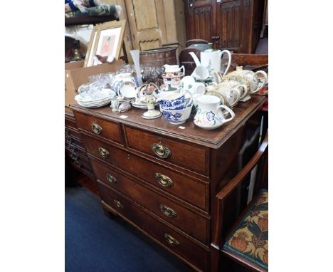 A GEORGE III OAK AND MAHOGANY CROSSBANDED CHET OF DRAWERS, on bracket feet, 93cm wide