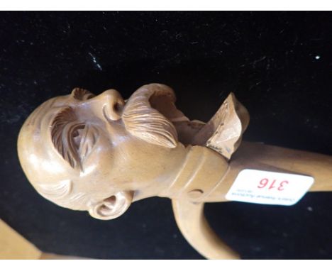 A 19TH CENTURY CARVED SYCAMORE NOVELTY NUTCRACKER, in the form of a bald man with a walrus moustache 21 cm long
