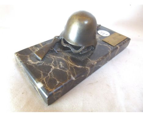 HELMET AND RIFLE. German helmet and rifle paperweight
