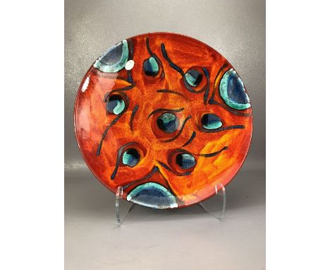Poole pottery Peacock charger, with turquoise decoration on orange and red ground, approx 40cm in diameter