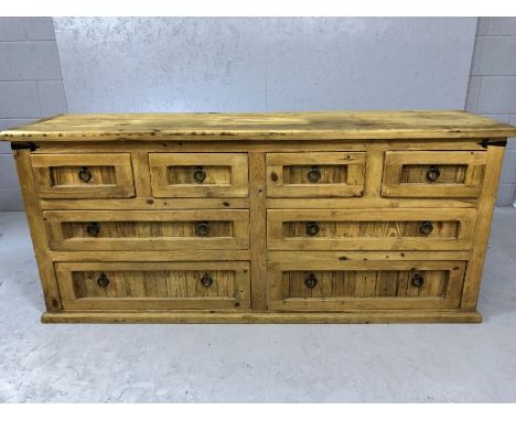 Mexican pine chunky modern sideboard with eight drawers and metal ring handles, approx 170cm x 44cm x 76cm tall