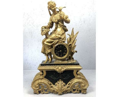 Gilt and spelter clock, depicting a lady feeding a bird.  French barrel movement, lightly bells the hour and half hour, resto