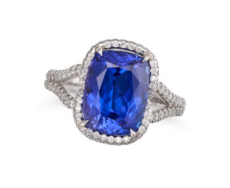 A TANZANITE AND DIAMOND RING in platinum, set with a cushion cut tanzanite of approximately 4.40 carats in a border of round 