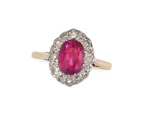 A RUBY AND DIAMOND RING set with an oval cut ruby of 0.72 carats in a border of single cut diamonds, stamped 18CT, size N / 6