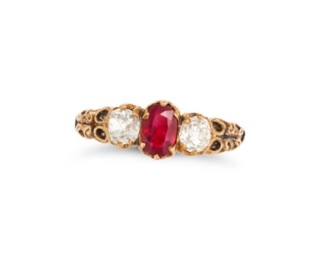 AN ANTIQUE RUBY AND DIAMOND THREE STONE RING in yellow gold, set with an oval cut ruby of approximately 0.78 carats accented 