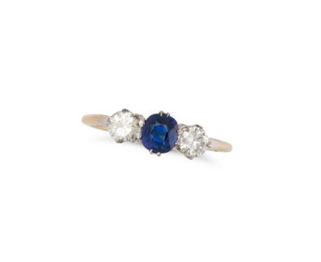 A SAPPHIRE AND DIAMOND THREE STONE RING set with a cushion cut sapphire between two round brilliant cut diamonds, no assay ma