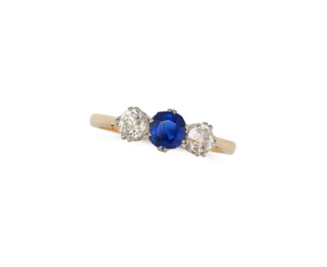 A SAPPHIRE AND DIAMOND THREE STONE RING set with a cushion cut sapphire between two old cut diamonds, stamped PLAT 18CT, size